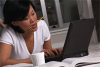 Hunched over a desk